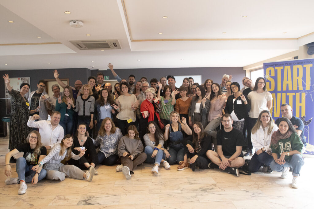 Group photo of about 45 people from various backgrounds and countries